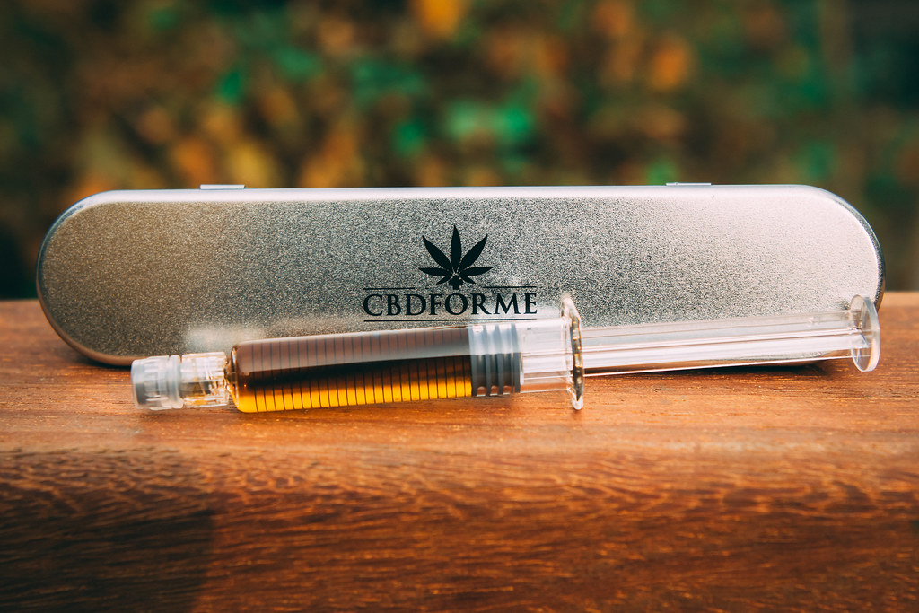CBD oil applicator in a metal tin